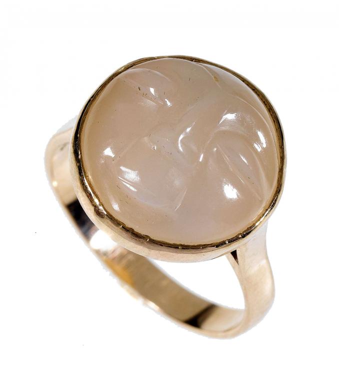 Appraisal: A MOONSTONE RING the cabochon carved as the 'Man in