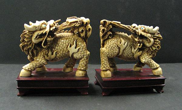 Appraisal: A pair of stained ivory figures Each portraying a mythical