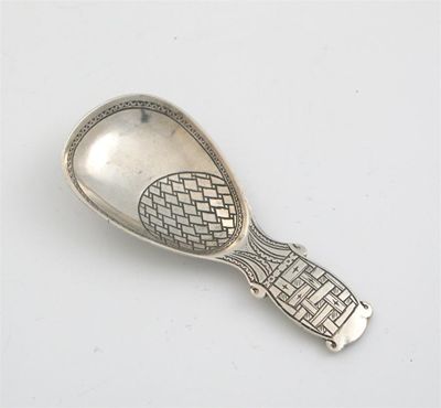 Appraisal: A modern caddy spoon with panels of engraved scale and