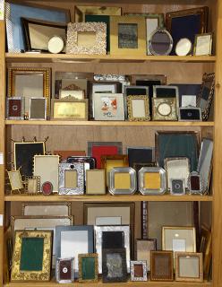 Appraisal: Four shelves of picture frames wall hanging and easel back