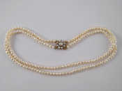 Appraisal: A two row cultured pearl necklace with a yellow metal