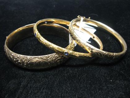 Appraisal: Three gold bangles all etched with intricate designs One with