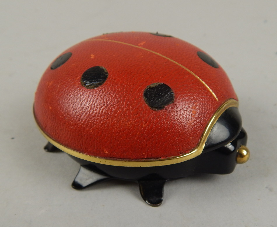 Appraisal: A thC Looping jewel eight day alarm travelling ladybird clock