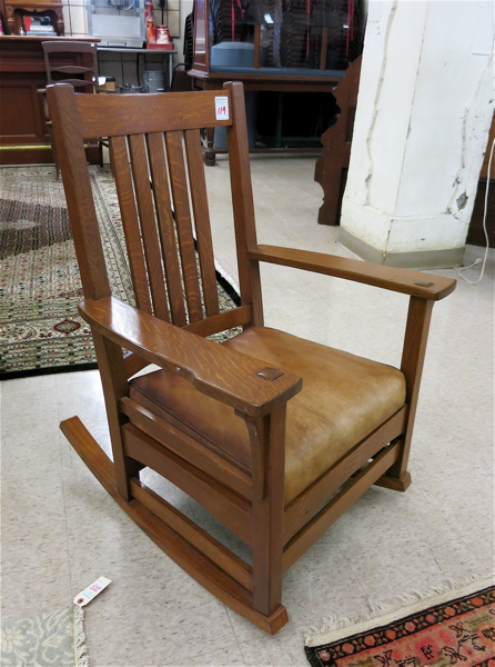 Appraisal: TWO OAK ROCKING CHAIRS Craftsman style American c rocking armchair