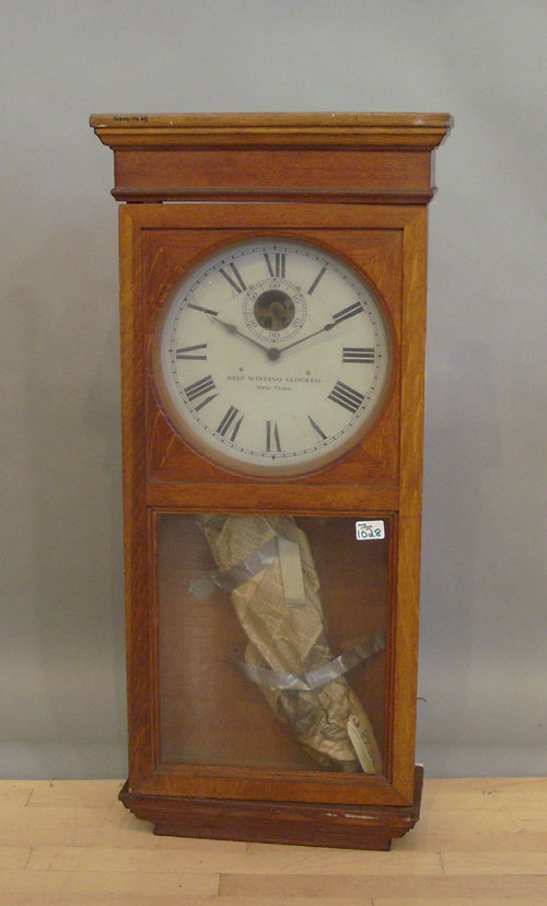 Appraisal: Self Winding Clock Co oak wall clock h w Deaccessioned