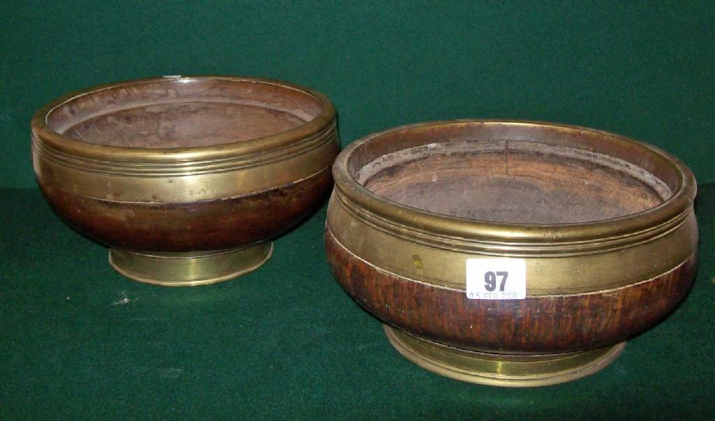 Appraisal: A turned wooden bowl with brass rim and foot and