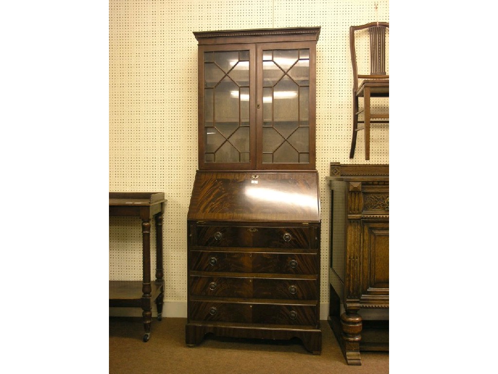 Appraisal: A reproduction mahogany bureau bookcase pair of astragal doors enclosing