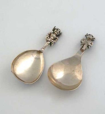 Appraisal: Two modern caddy spoon with cast Lincoln Imp terminals and