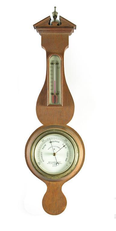 Appraisal: Negretti and Zambra An oak banjo shape aneroid barometer