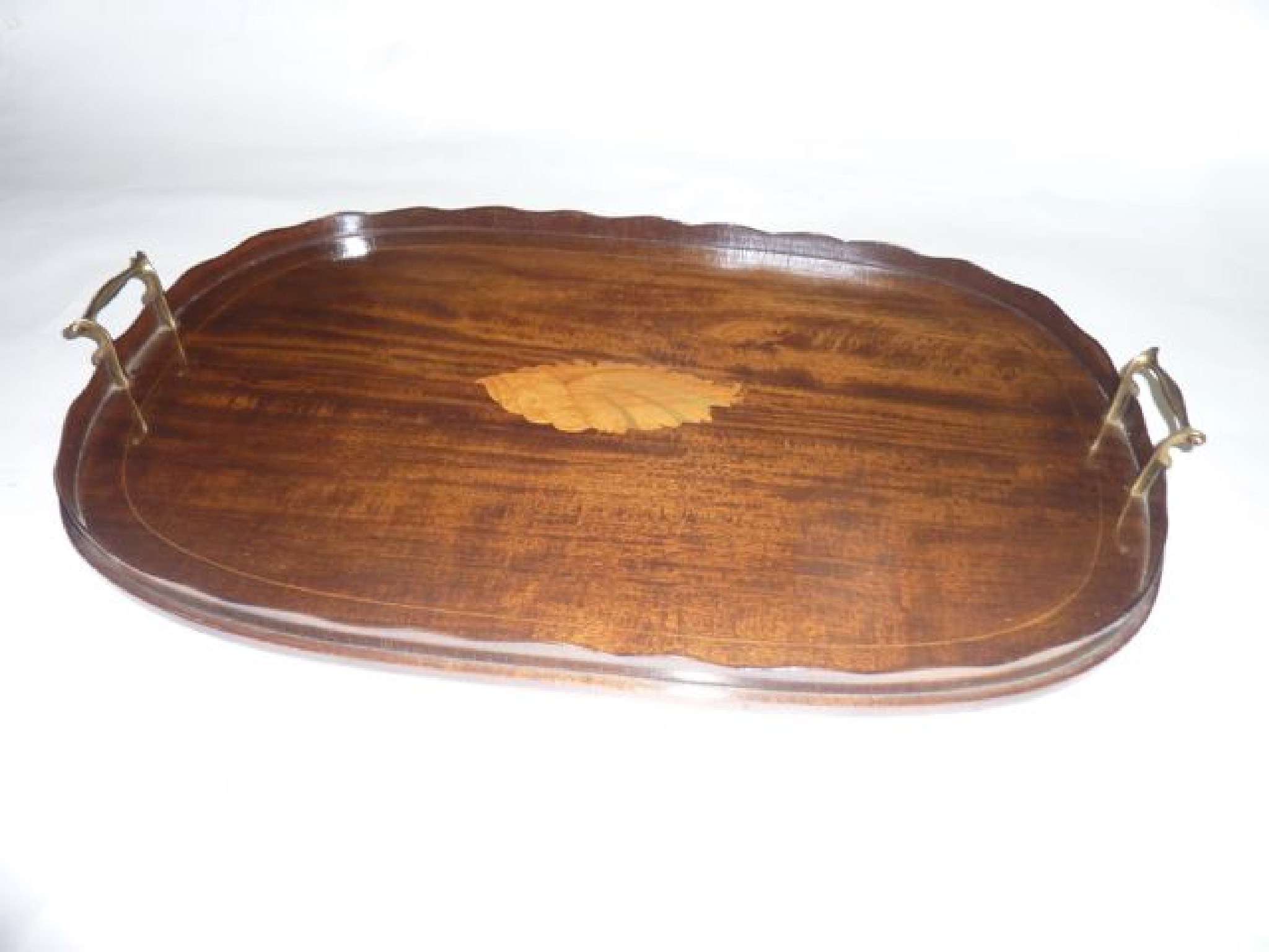 Appraisal: An Edwardian mahogany tray of oval form with shaped gallery