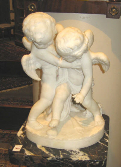 Appraisal: SCULPTED WHITE MARBLE FIGURE GROUP Showing two winged cherubs wrestling