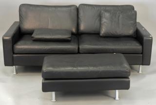 Appraisal: Modern Cor black leather two cushion sofa with ottoman lg