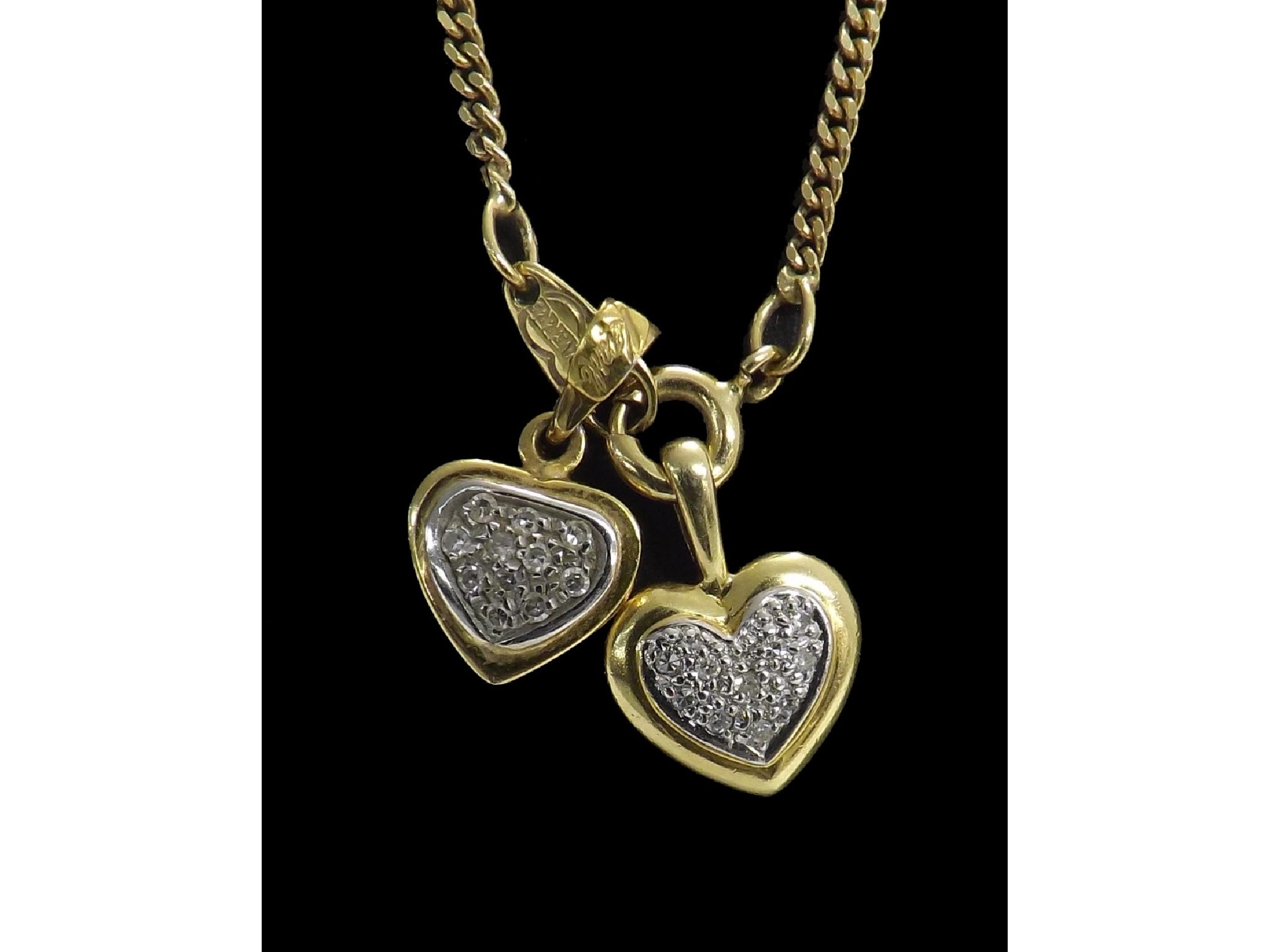 Appraisal: Two k diamond set heart pendants on necklet pendants mm