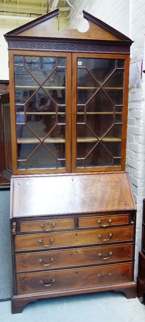 Appraisal: A th century marquetry inlaid mahogany bureau bookcase the broken