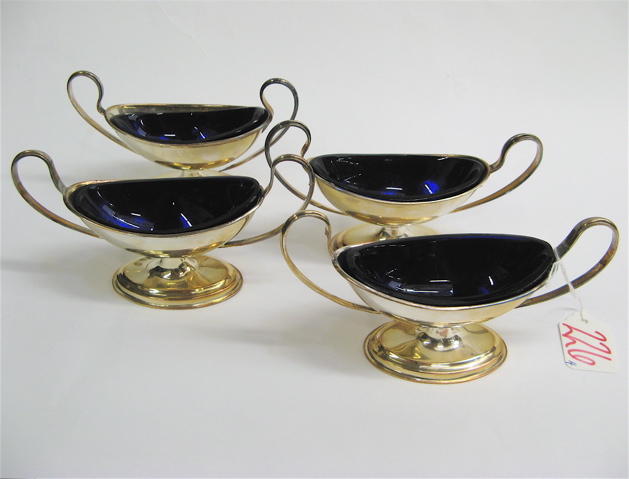 Appraisal: FOUR SILVER PLATED PEDESTAL SALTS oblong with cobalt blue glass