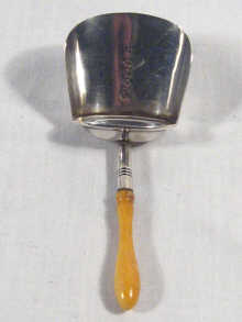 Appraisal: A silver caddy spoon with turned ivory handle by Joseph