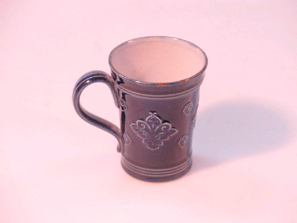 Appraisal: A Royal Doulton stoneware mug with blue glaze and stylized