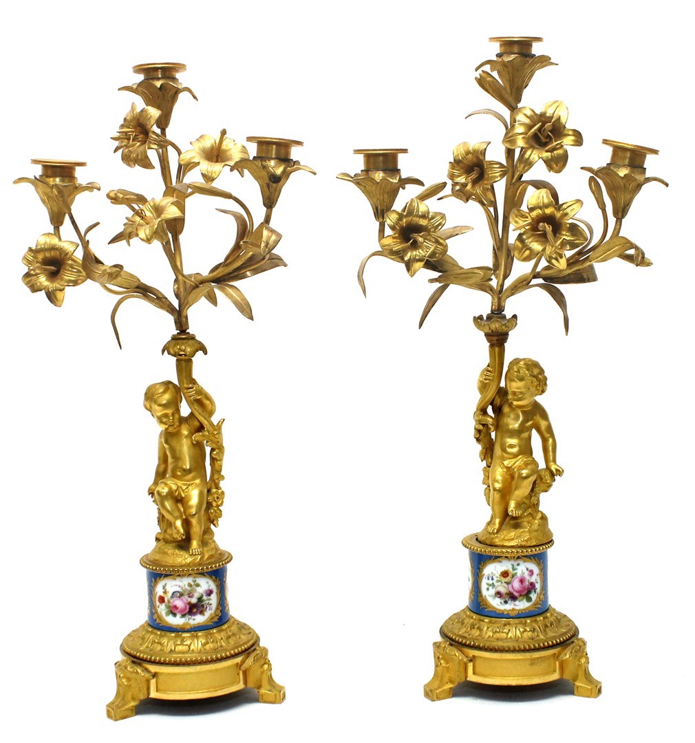 Appraisal: A pair of French gilt bronze mounted porcelain figural candelabra