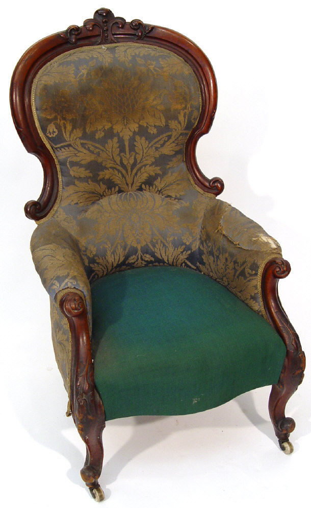 Appraisal: Victorian mahogany framed spoonback armchair with carved mouldings and green