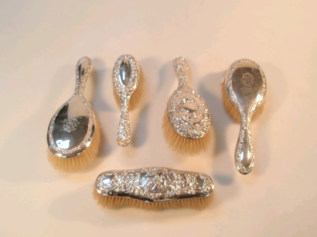 Appraisal: A pair of silver backed hairbrushes Birmingham two further similar