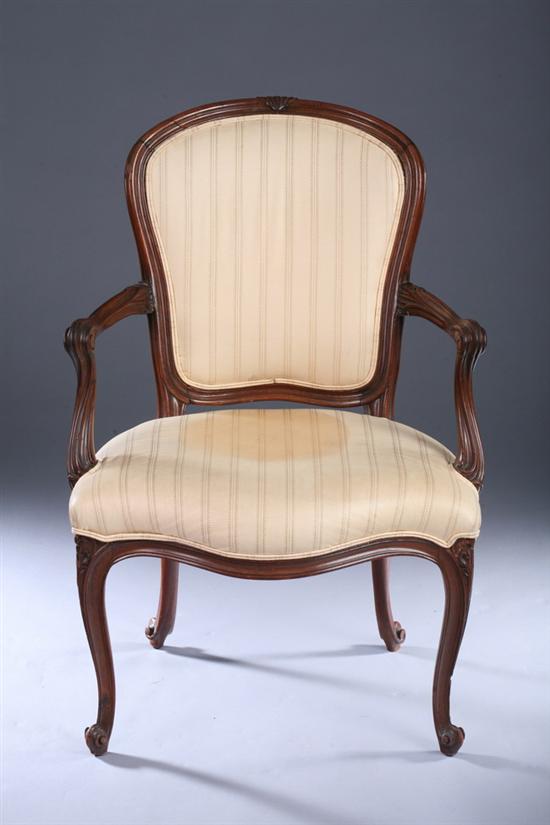 Appraisal: LOUIS XV STYLE CARVED FRUITWOOD FAUTEUIL th century butter-stripe upholstery