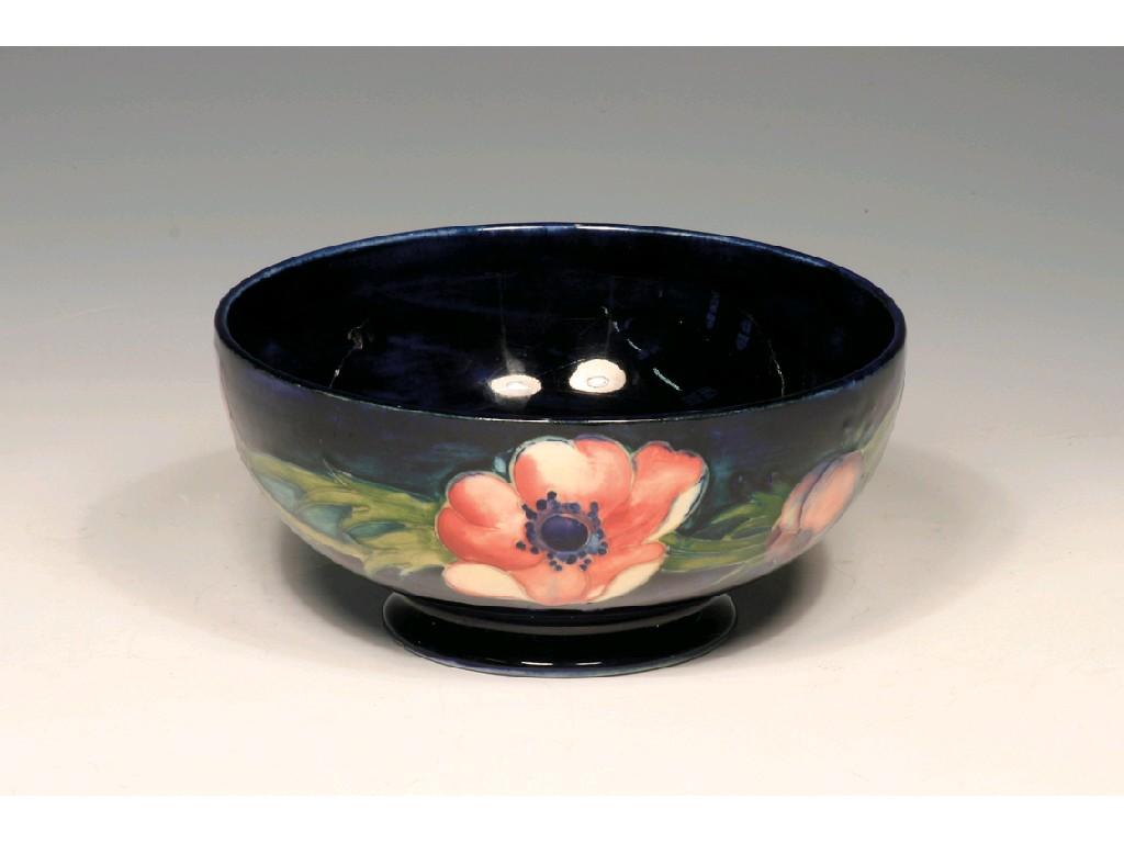 Appraisal: A MOORCROFT ANEMONE PATTERN FOOTED BOWL decorated with flowers and