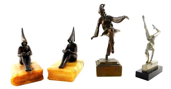 Appraisal: Four Art Deco and Deco style cast-metal acrobat clown and