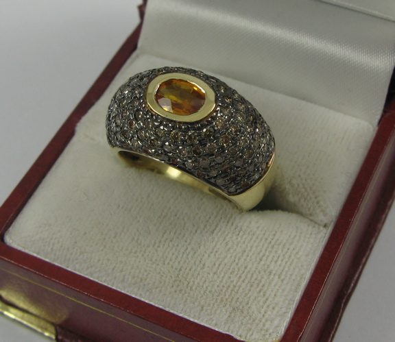 Appraisal: YELLOW SAPPHIRE AND K GOLD RING centering an oval-cut yellow