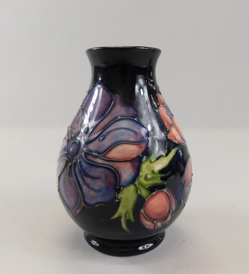 Appraisal: A Moorcroft bud vase decorated with pink and purple flowers