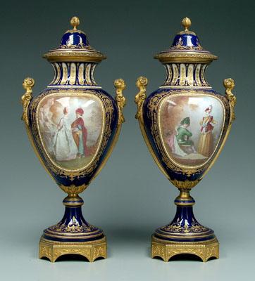 Appraisal: Pair S vres urns both sides with hand painted panels