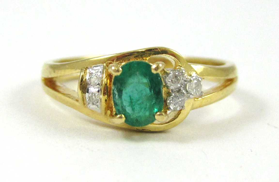 Appraisal: EMERALD DIAMOND AND FOURTEEN KARAT GOLD RING with three round-cut