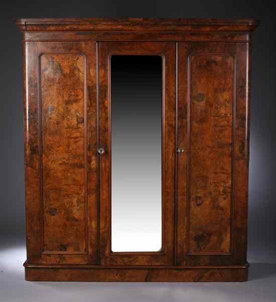 Appraisal: RUSSIAN KARELIAN BIRCH ARMOIRE th century Molded cornice three hinged