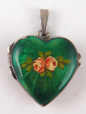 Appraisal: A silver and enamel heart shape locket approx cm