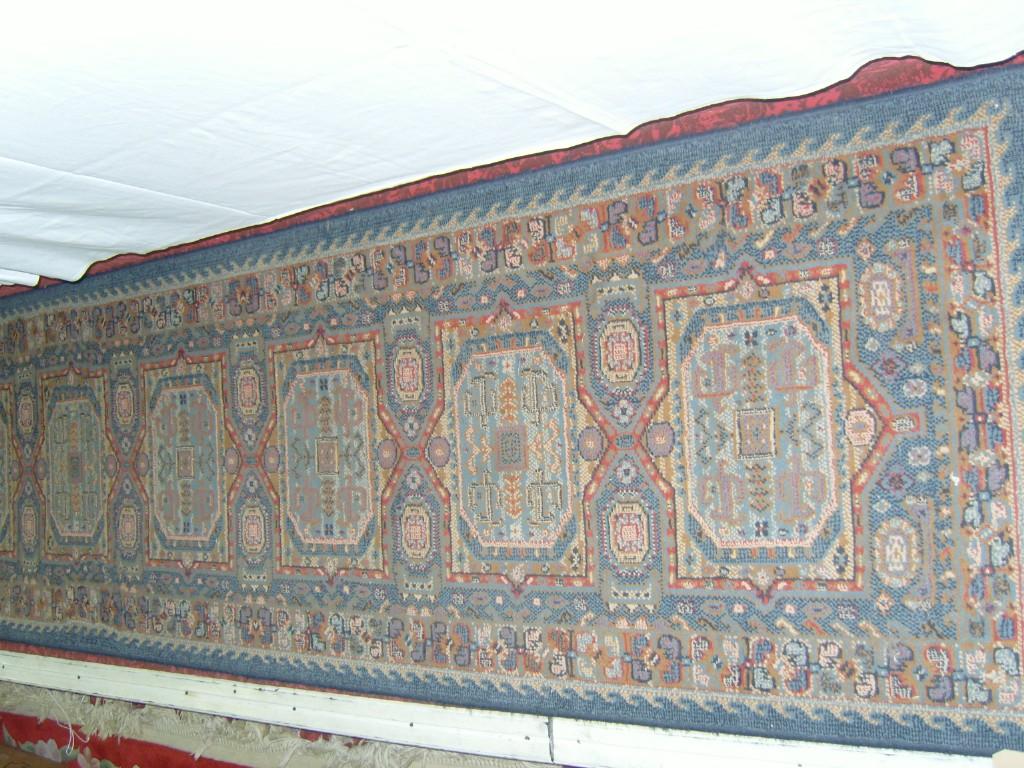 Appraisal: A blue ground wool runner with repeating decoration in red