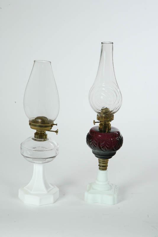 Appraisal: TWO OIL LAMPS One with a milk glass base leaf