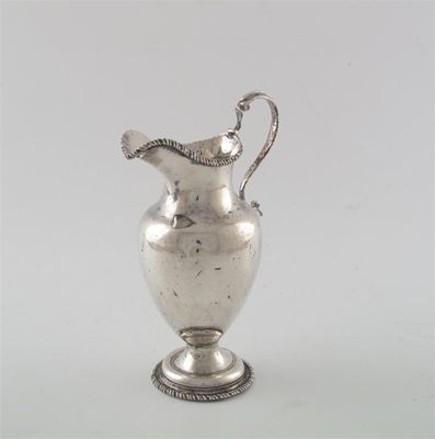 Appraisal: A George III oviform cream jug with gadrooned borders and