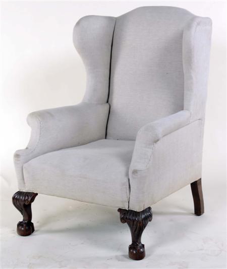 Appraisal: An early th century wing back armchair the arched back