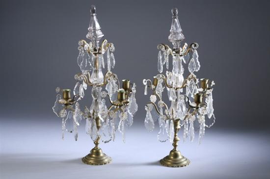 Appraisal: PAIR VICTORIAN BRASS AND CRYSTAL THREE-LIGHT CANDELABRA th century Glass-cased