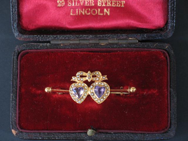 Appraisal: A VICTORIAN ENTWINED HEART STICK PIN each heart-shaped amethyst with