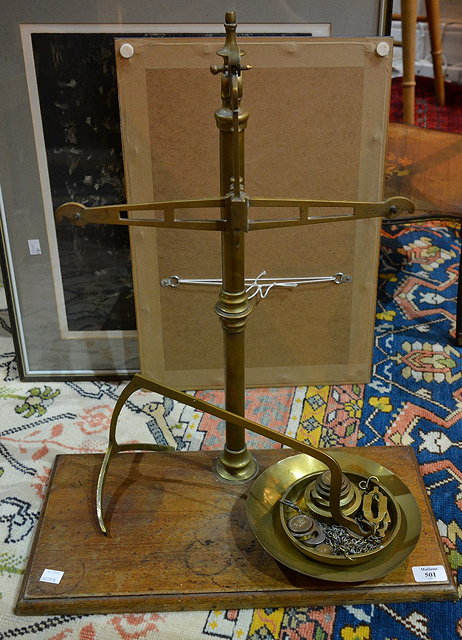 Appraisal: Victorian brass balance scaleswith graduated weights on a rectangular mahogany