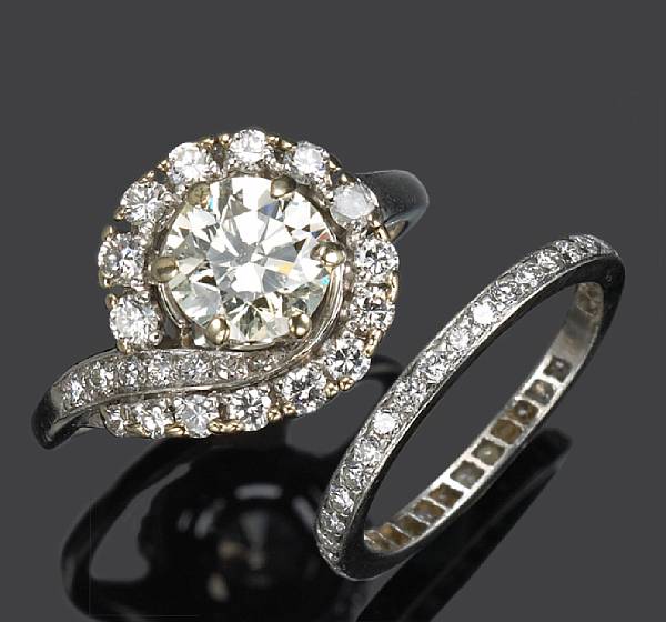 Appraisal: A diamond solitaire ring centering a transitional-cut diamond accompanied with