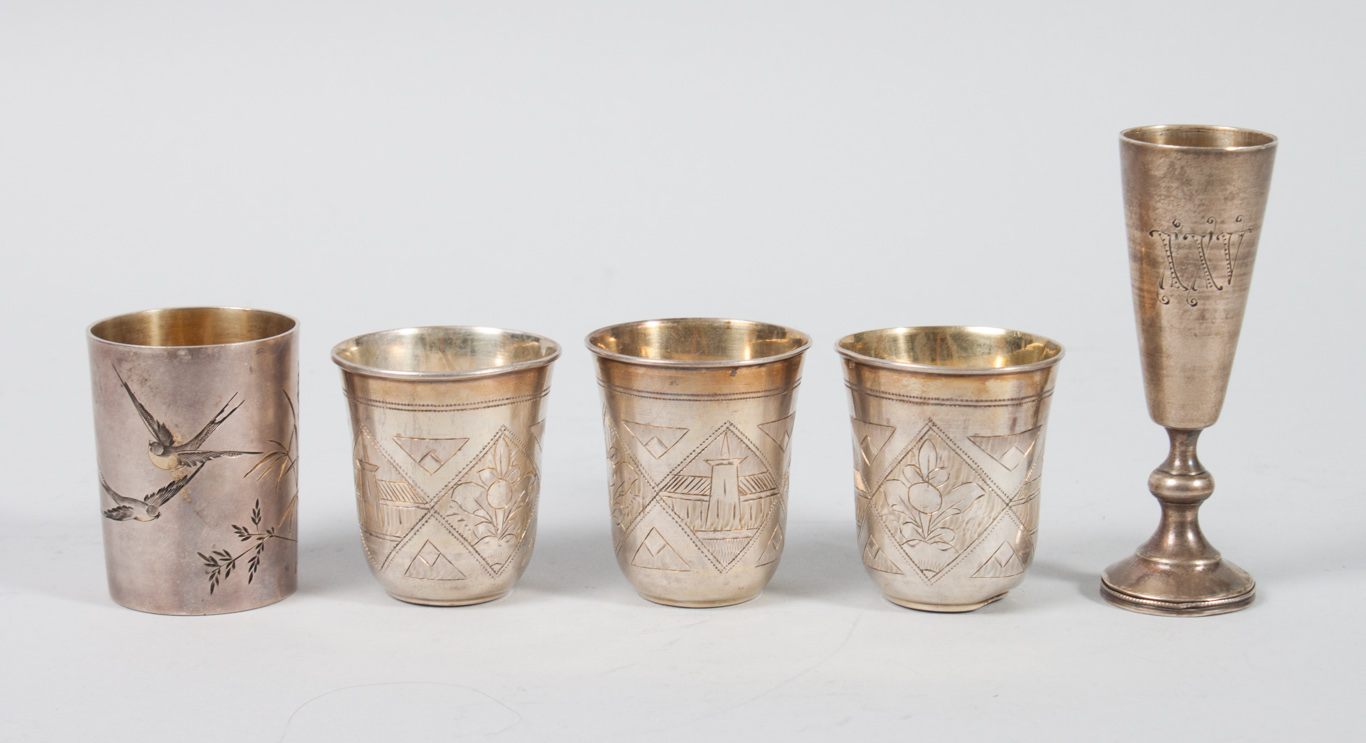 Appraisal: Russian engraved and gilt silver vodka cups comprising one with