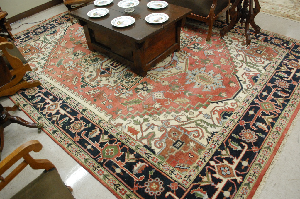 Appraisal: HAND KNOTTED ORIENTAL CARPET Persian Serapi design central geometric medallion