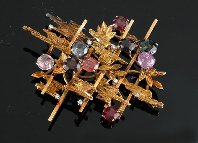 Appraisal: A multi-gem set cocktail brooch Designed as an abstract gold