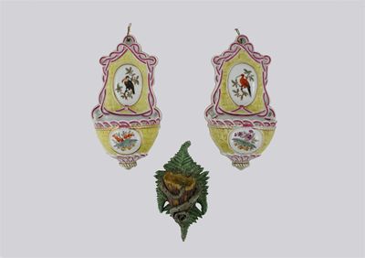 Appraisal: A pair of continental wall pockets each decorated with a