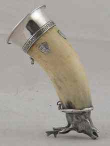 Appraisal: A drinking horn with white metal stag's head base and