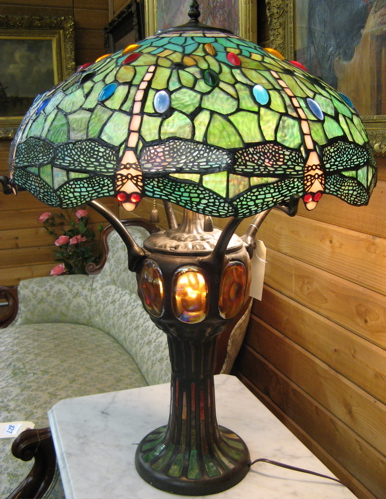 Appraisal: A LEADED GLASS AND PATINATED BRONZE DRAGONFLY TABLE LAMP having