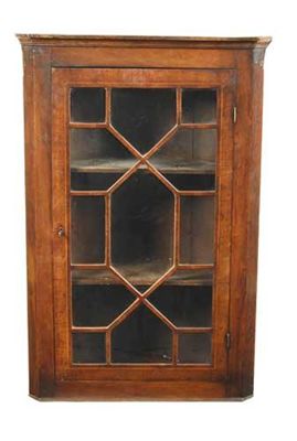 Appraisal: A George III mahogany hanging corner cupboard with an astragal