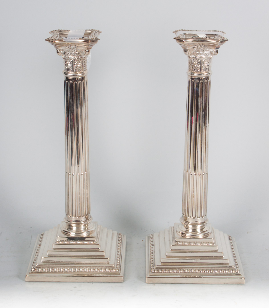 Appraisal: Pair of silver-plated columnar candlesticks Neoclassical style with stepped base