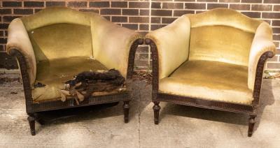 Appraisal: A pair of deep seated armchairs circa with carved rosette